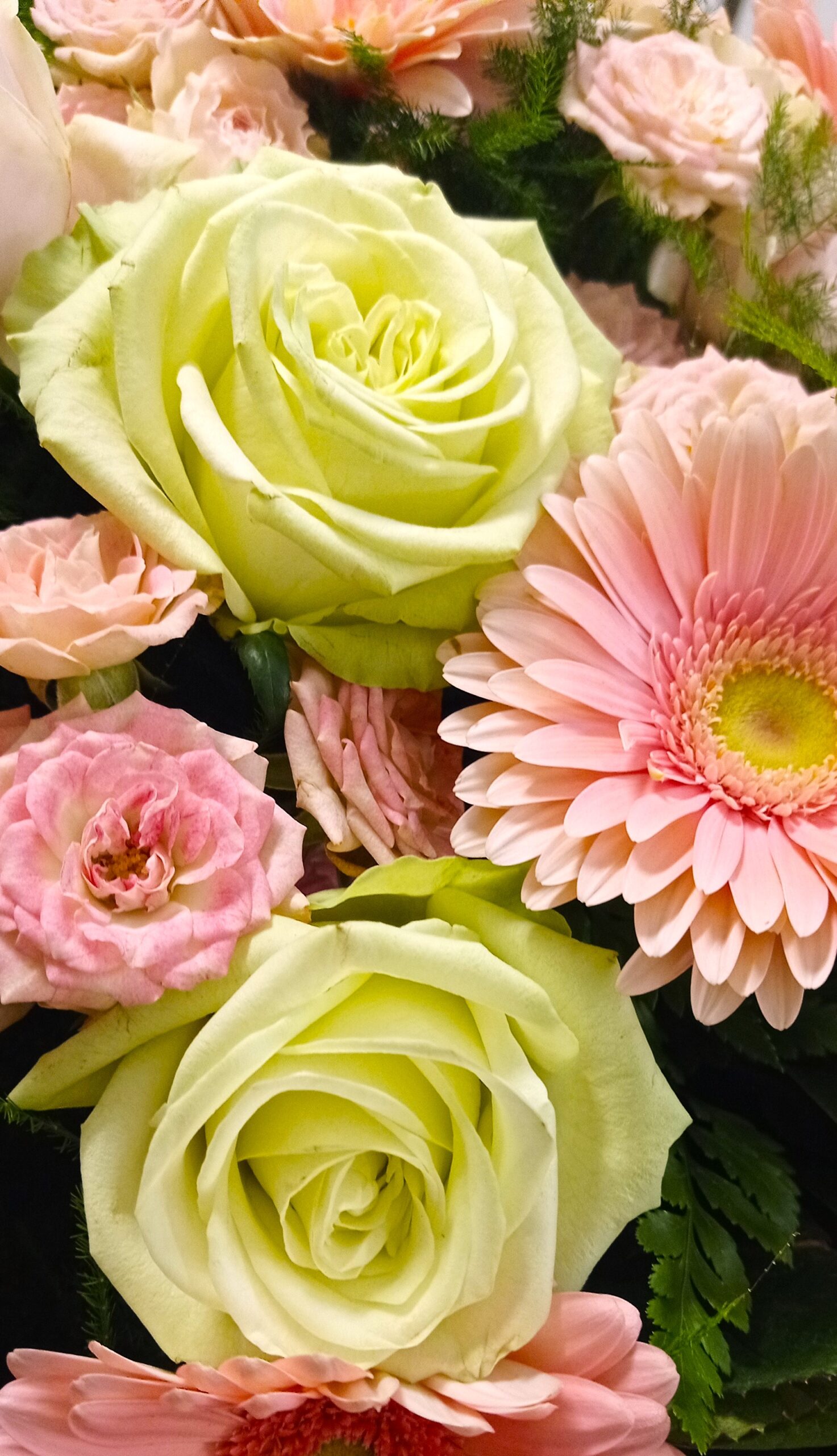 rose gialle con gerbere rosa in una composizione per funerale