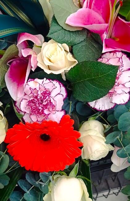 fiori funebri composti da rose, gerbere, garofani e lillium